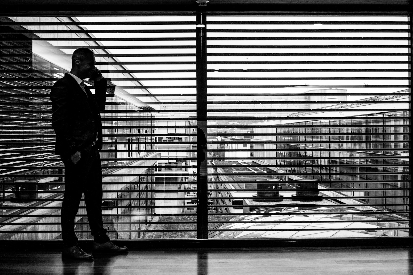 A professional taking a call by the office window